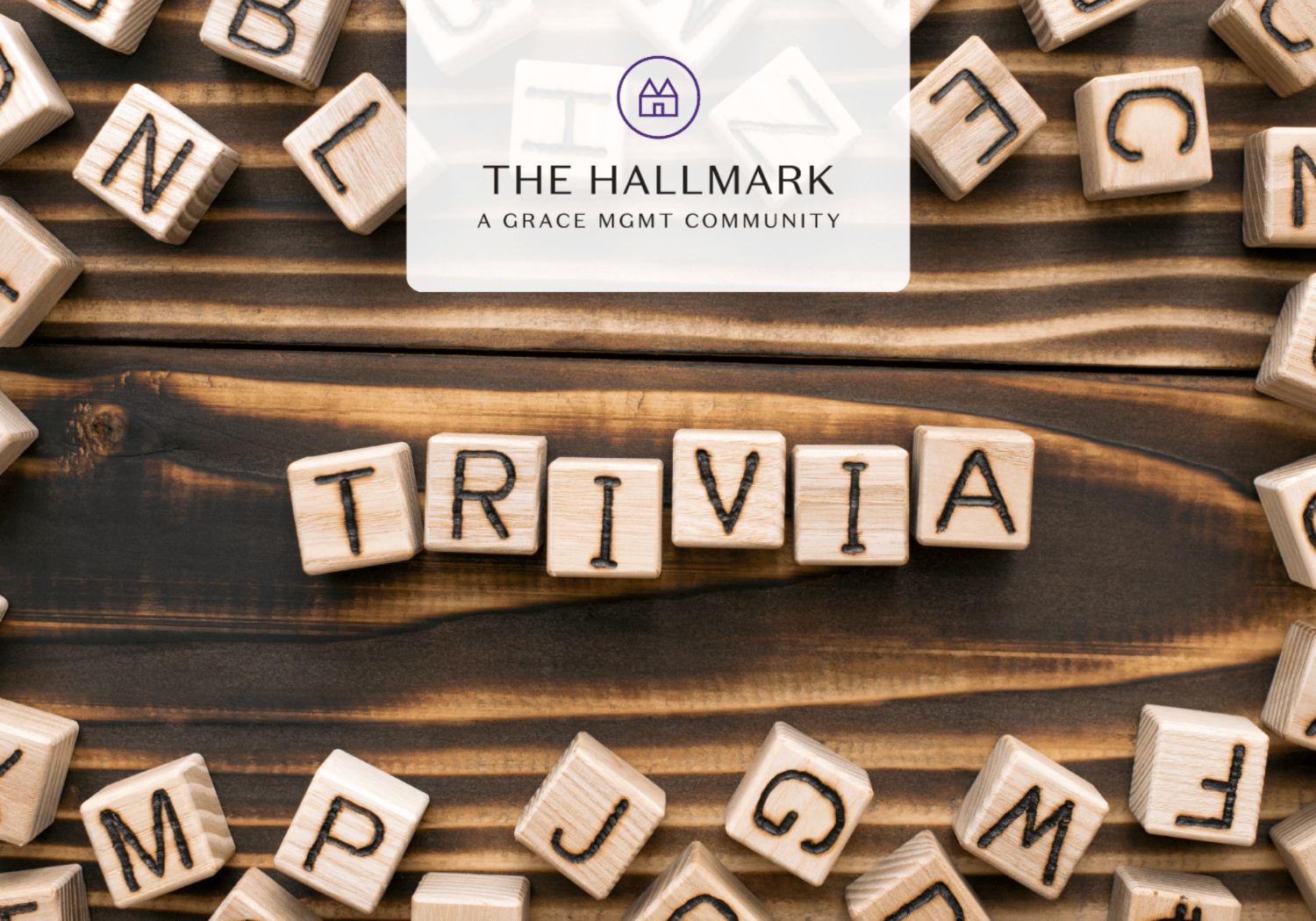 Wooden alphabet blocks spell 'TRIVIA' on a dark wood table, with a translucent logo reading 'THE HALLMARK A GRACE MGMT COMMUNITY' above.